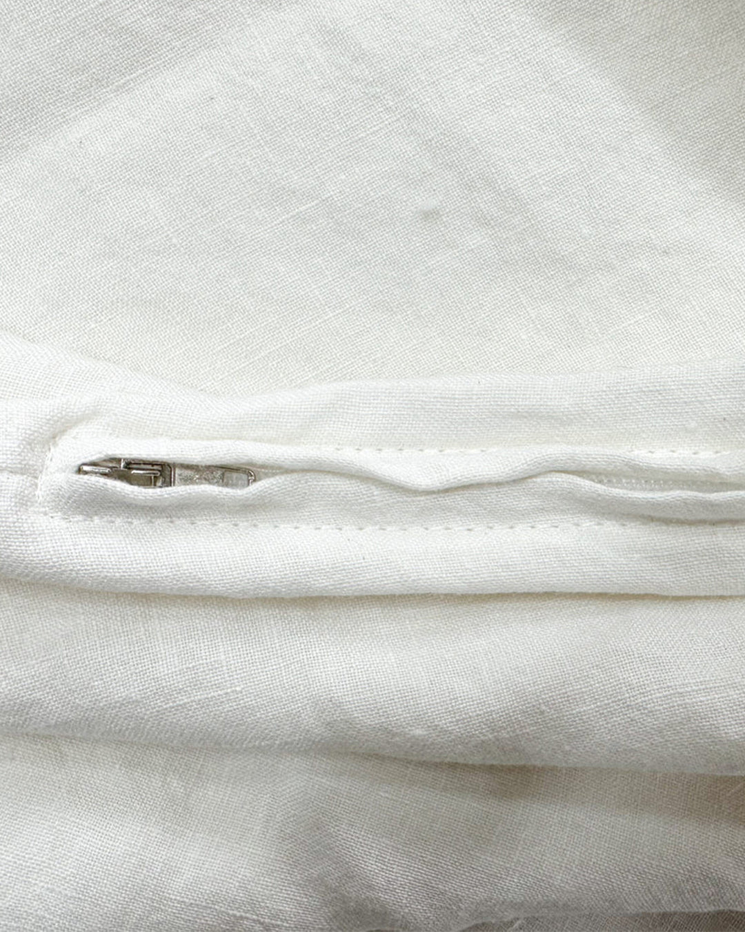 Detail of the hidden zipper closure on a Cream stonewashed flax linen duvet cover